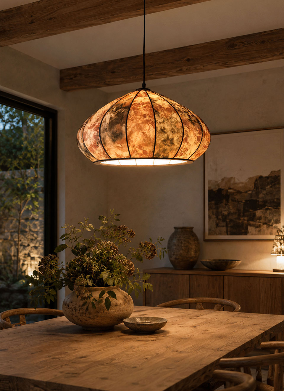 Handmade onion silk mushroom pendant glowing above a table.