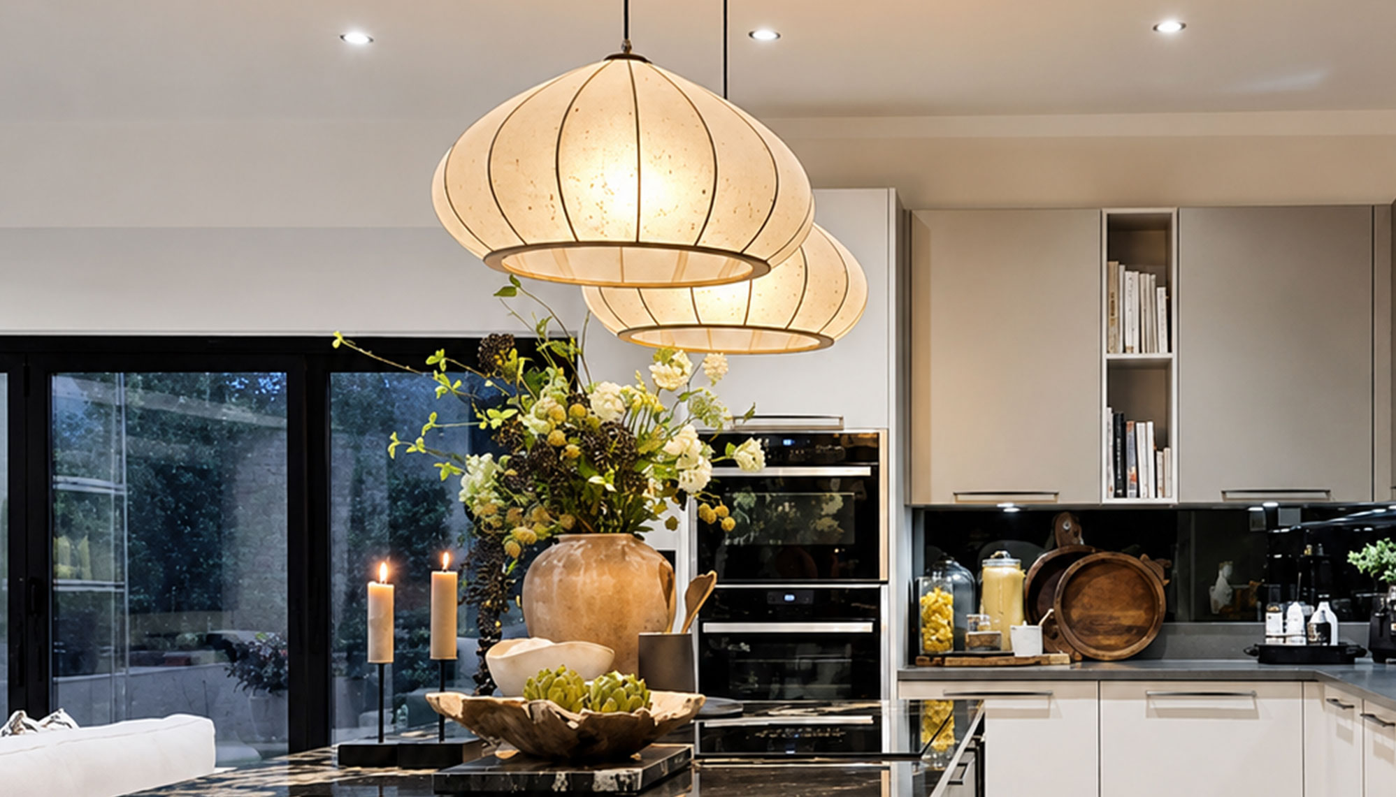 Handmade washi mushroom pendants glowing above a kitchen island.